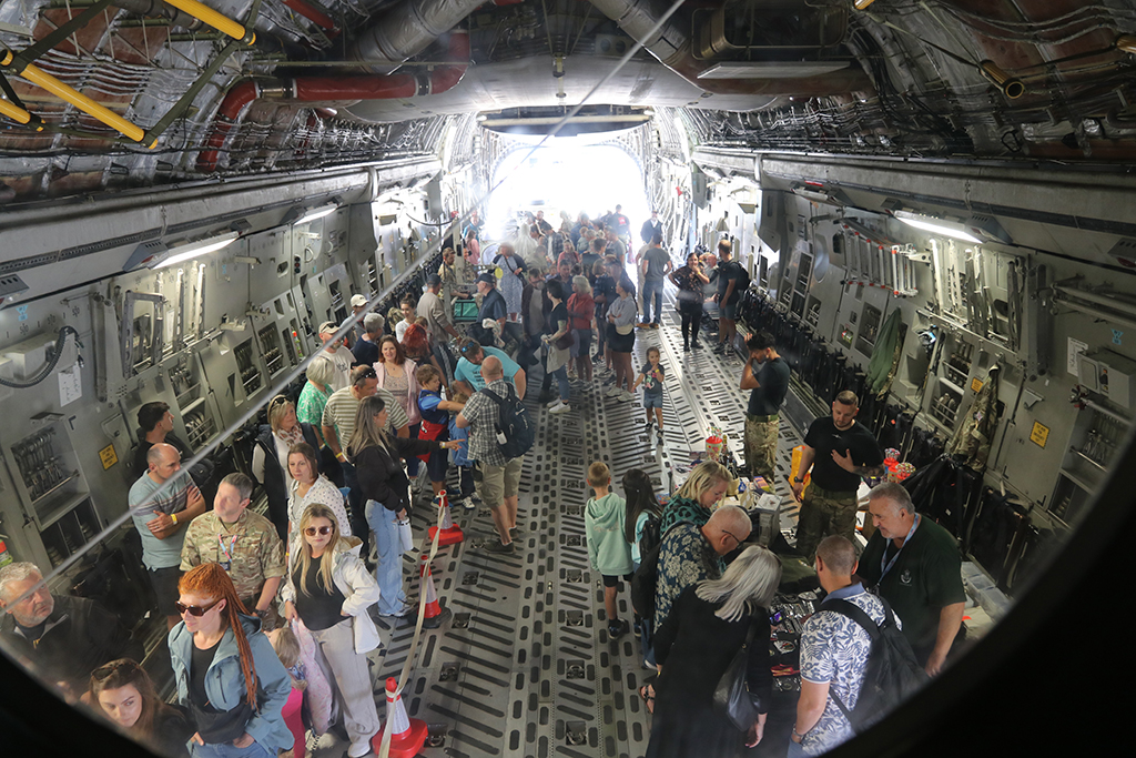 Families seen in the cargo bay inside the RAF Globemaster (C-17) having a look around and engaging with 99 Squadron members.